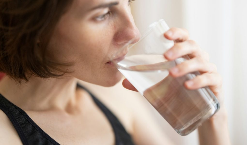 A woman drinking a glass of water