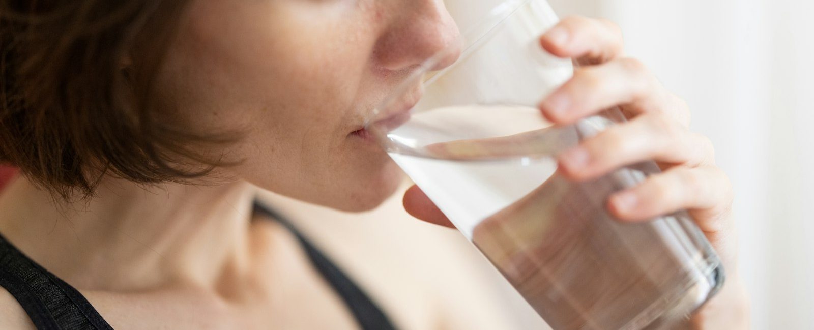 A woman drinking a glass of water