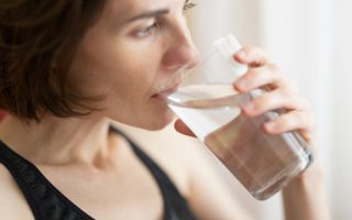 A woman drinking a glass of water