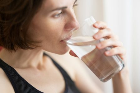 A woman drinking a glass of water